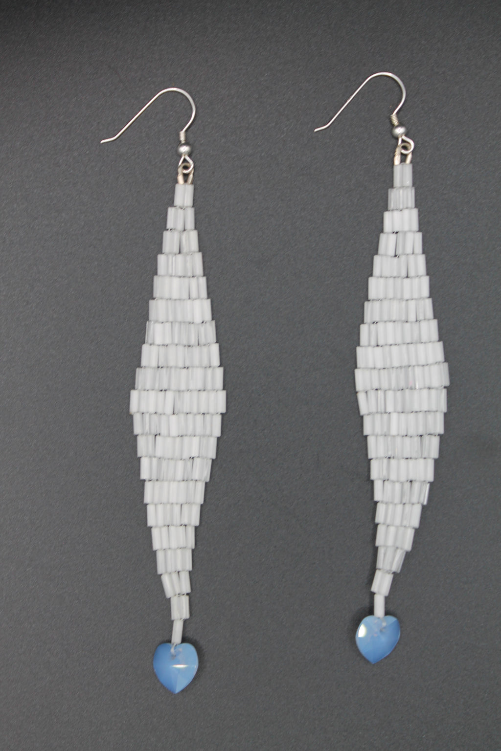 White shimmer drop earrings with blue heart charms
