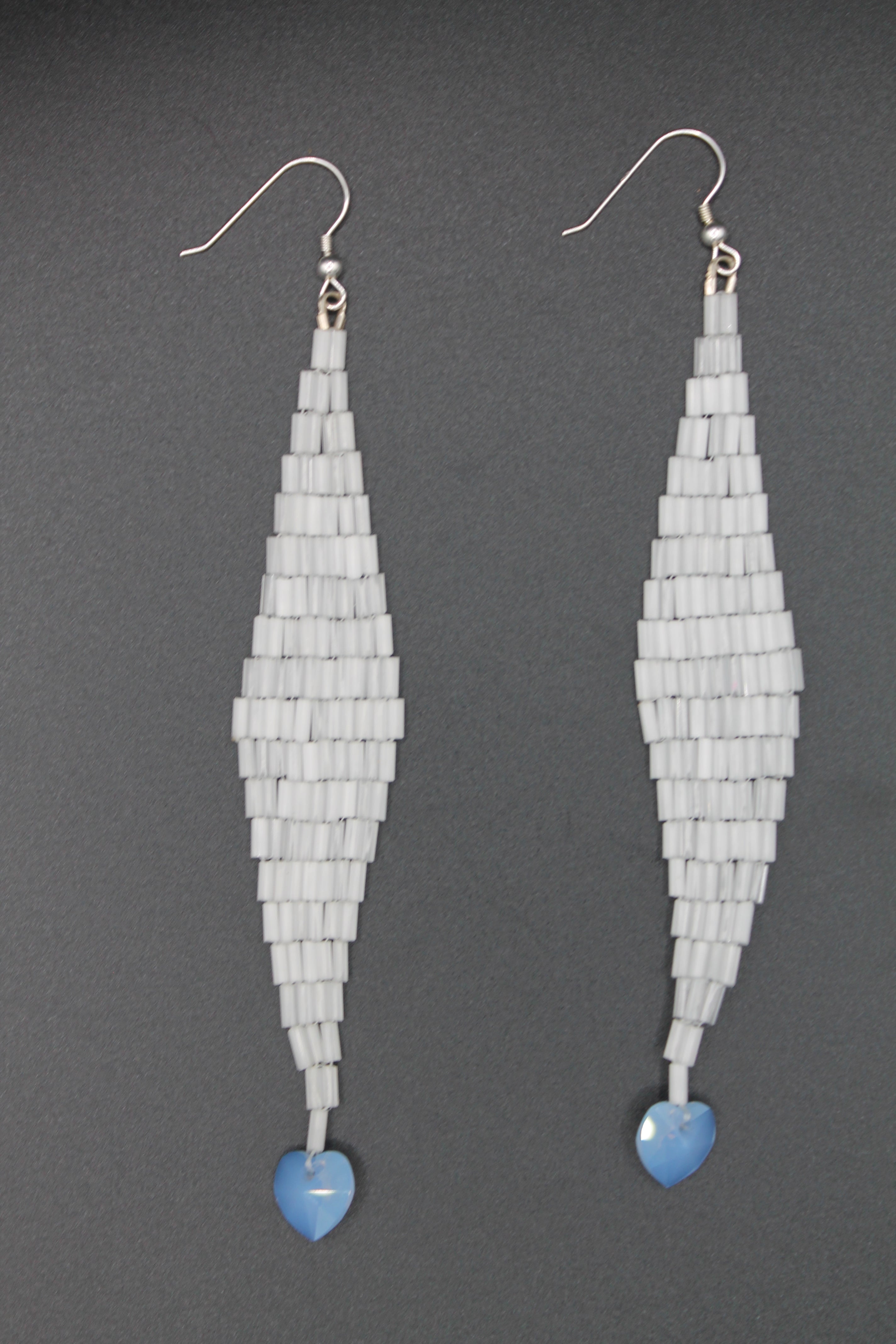 White shimmer drop earrings with blue heart charms
