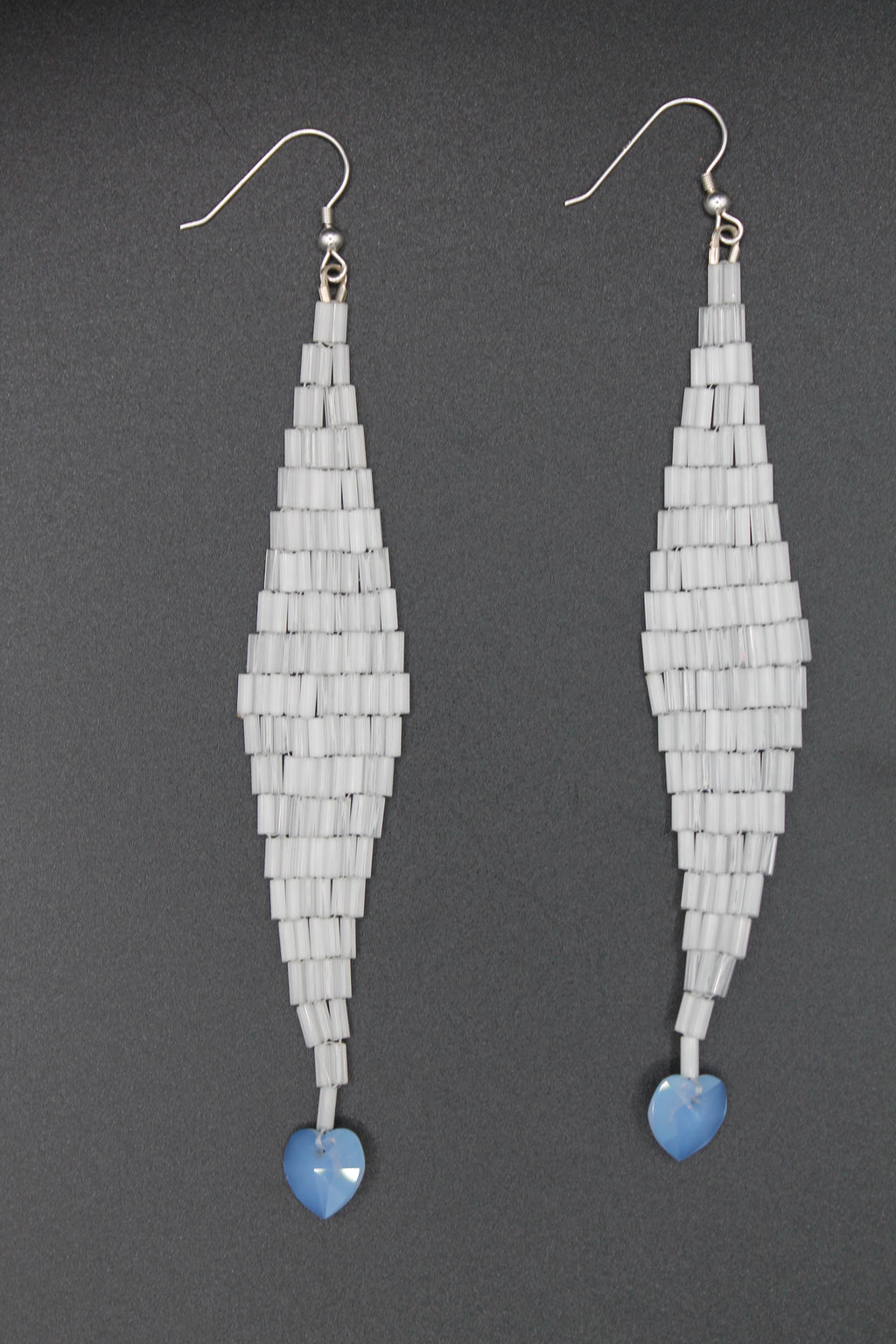 White shimmer drop earrings with blue heart charms