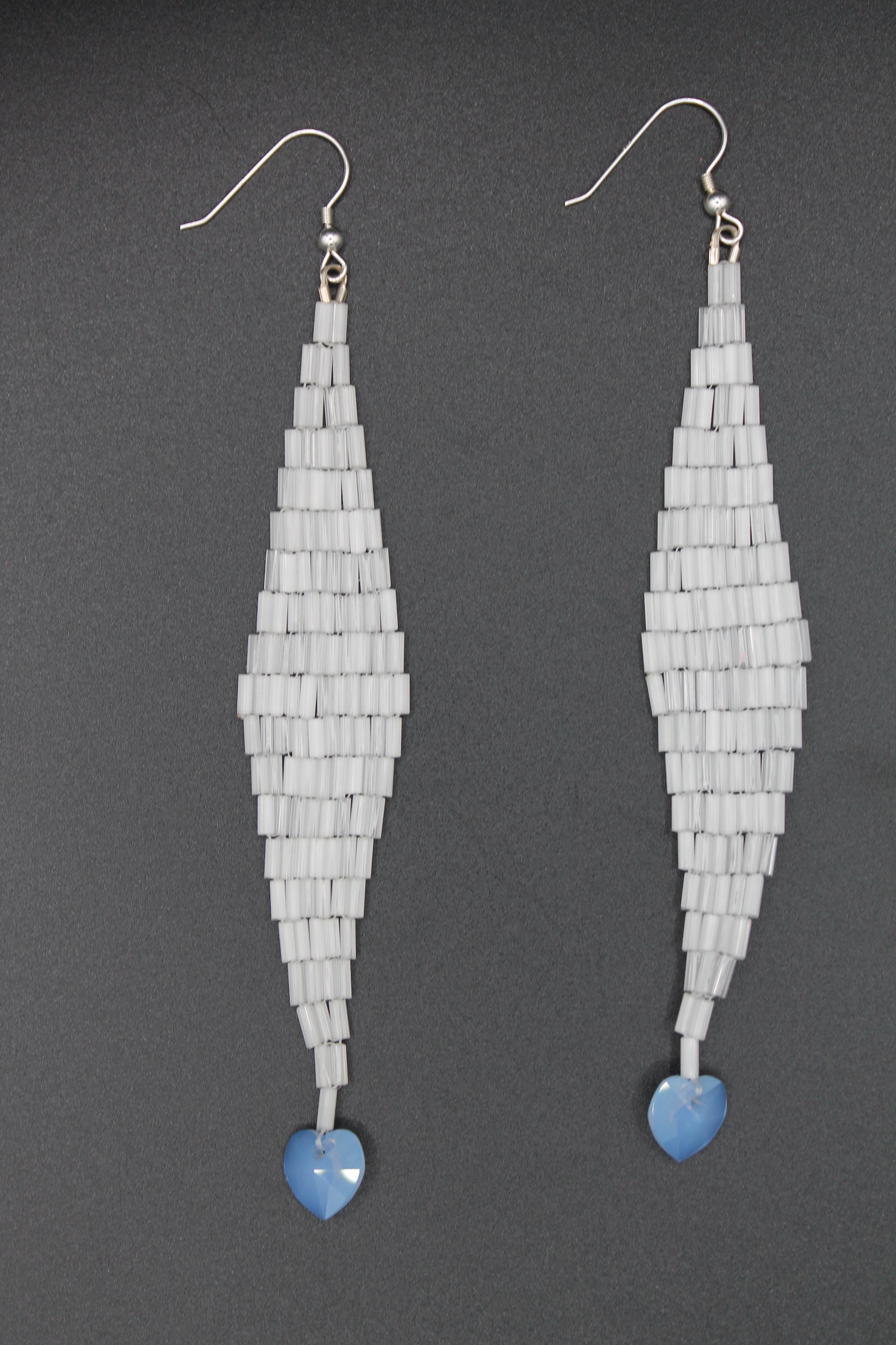 White shimmer drop earrings with blue heart charms